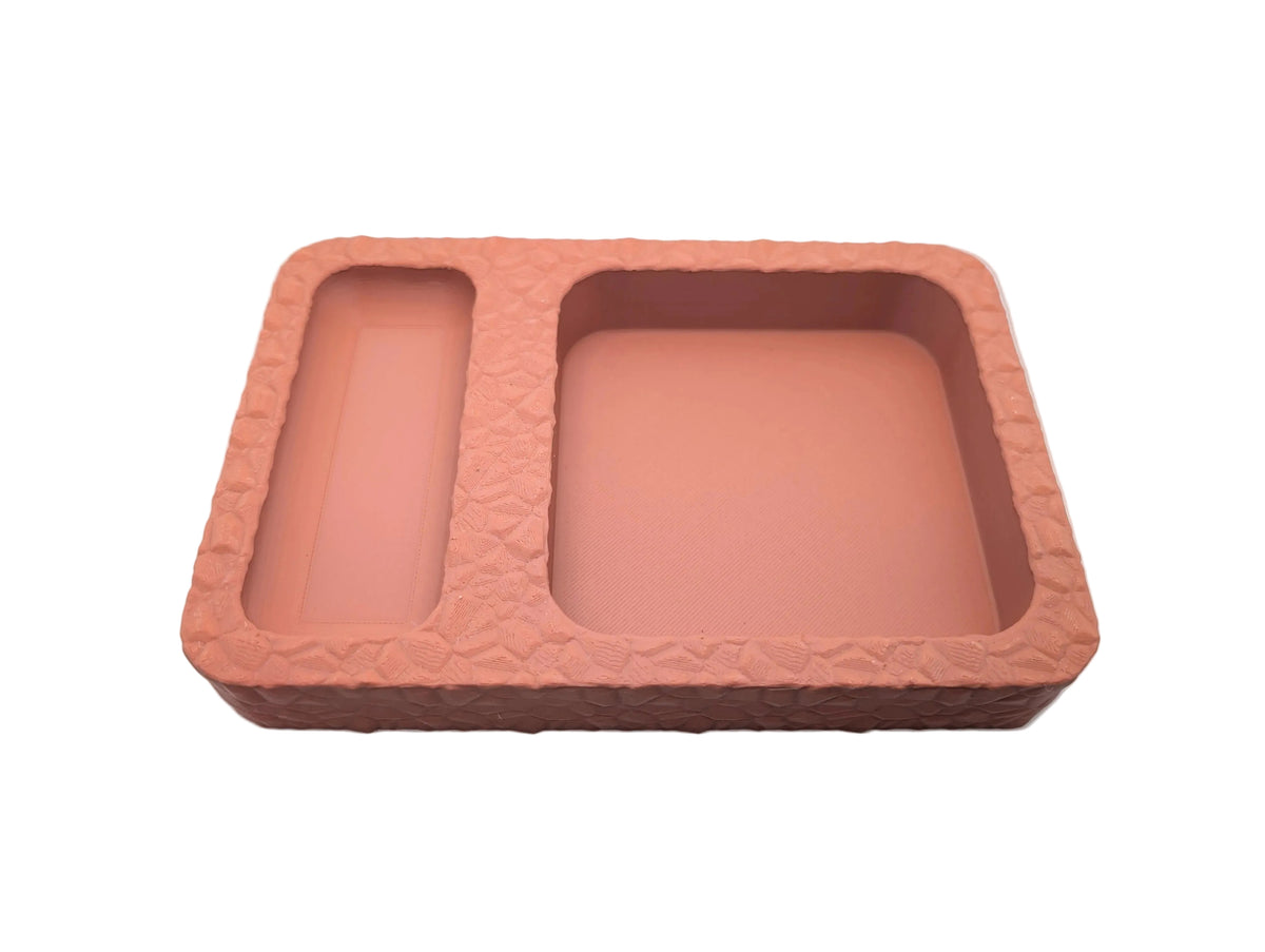 A grey dice tray with two compartments for storing and rolling dice during role play table top games