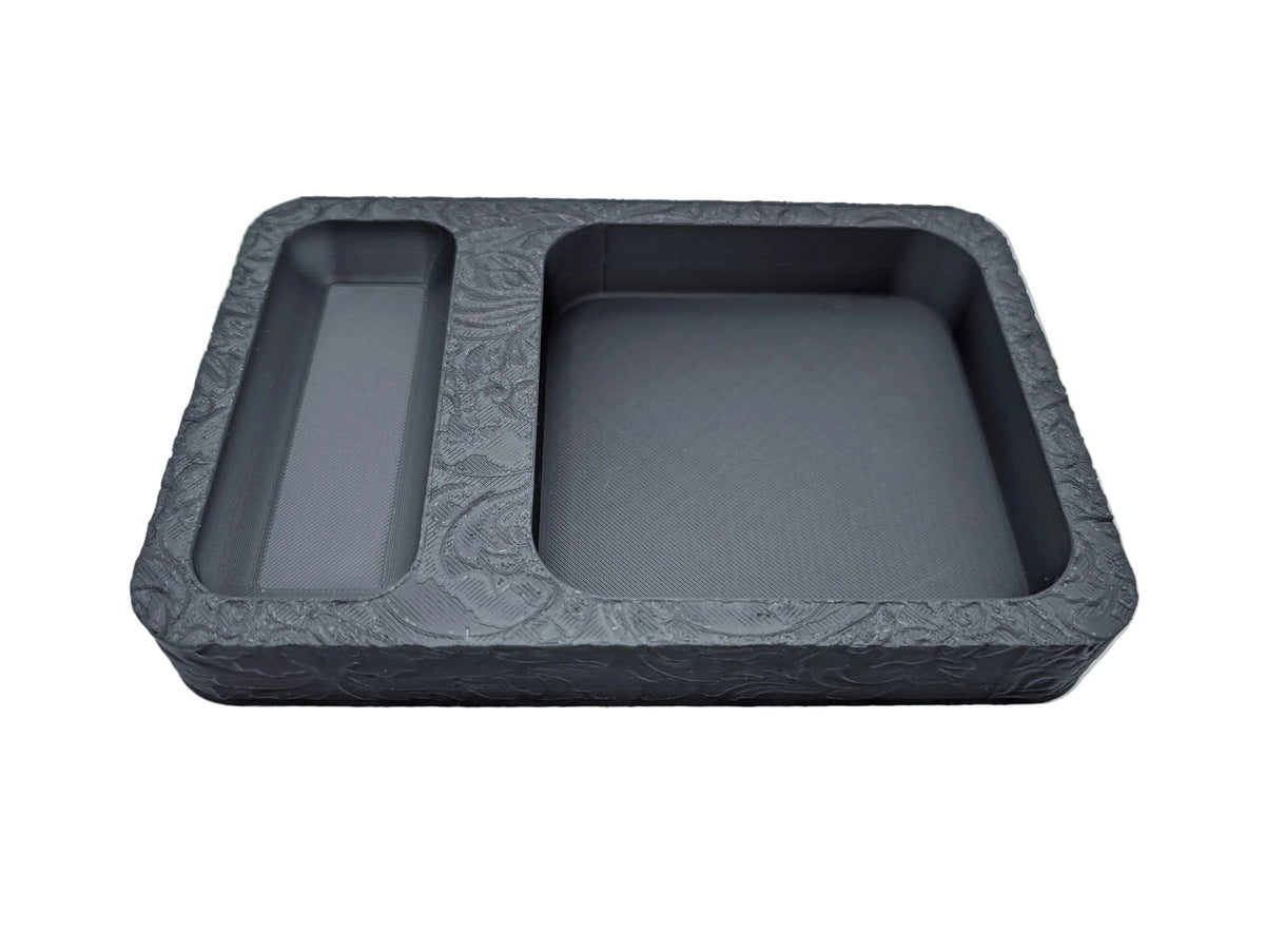 A black dice tray with two compartments for storing and rolling dice during role play table top games